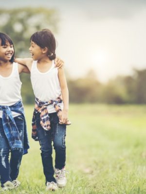 Two little girls hand holding together having fun in the park